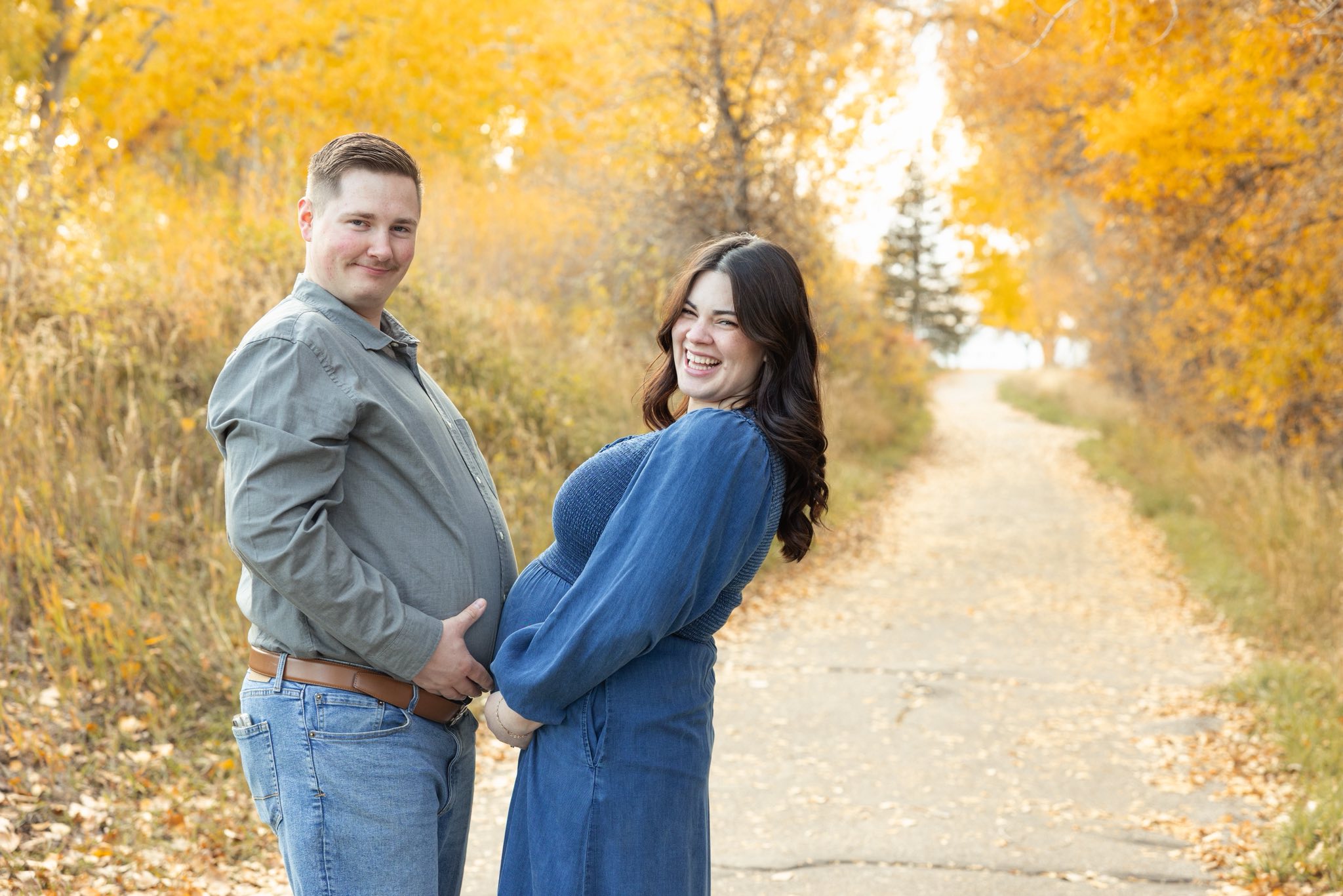 Picture of the couple grabbing their bellies